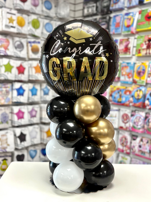 Black, Silver and Gold Congrats Grad  balloon centerpiece. Order for pick up or delivery at our Miller Place or Nesconset store locations.